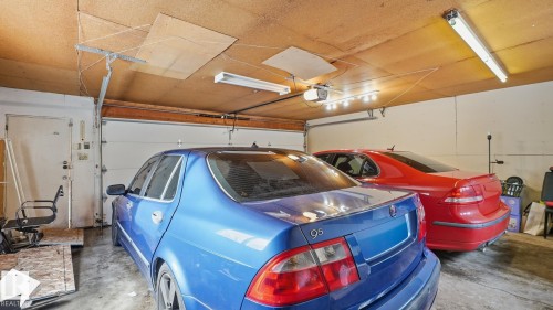 Garage with a garage door opener - 11520 78 Avenue Nw, Edmonton, AB - Indoor Photo Showing Garage