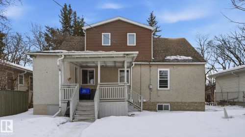 Snow covered property featuring covered porch and roof with shingles - 11520 78 Avenue Nw, Edmonton, AB - Outdoor