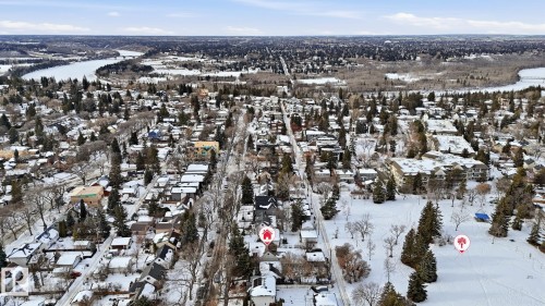 Aerial view of property and surrounding area with nearby suburban area and a large body of water - 11520 78 Avenue Nw, Edmonton, AB - Outdoor With View