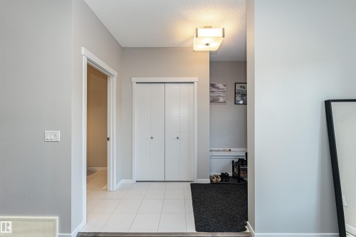 Foyer entrance with a textured ceiling and light tile patterned floors - 4008 Allan Crescent, Edmonton, AB - Indoor