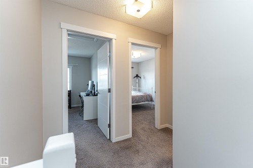 Hallway with a textured ceiling and light colored carpet - 4008 Allan Crescent, Edmonton, AB - Indoor Photo Showing Other Room