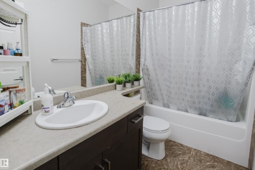 Bathroom with vanity and shower / bath combination with curtain - 415 2203 44 Avenue, Edmonton, AB - Indoor Photo Showing Bathroom