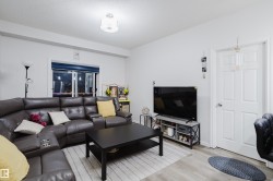 Living area with wood finished floors and a textured ceiling - 