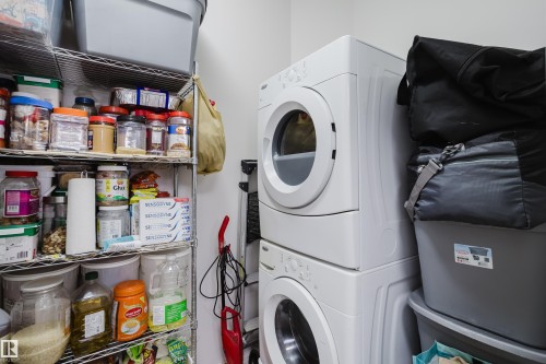 Laundry area with stacked washer and clothes dryer - 415 2203 44 Avenue, Edmonton, AB - Indoor Photo Showing Laundry Room