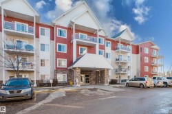 View of apartment building / complex featuring uncovered parking - 