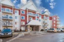View of apartment building / complex featuring uncovered parking - 415 2203 44 Avenue, Edmonton, AB  - Outdoor With Facade 