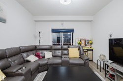 Living room featuring wood finished floors and a textured ceiling - 