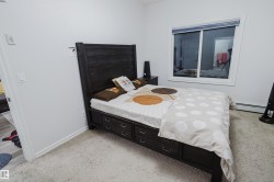 Bedroom with light carpet and baseboards - 