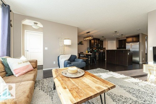 Living area featuring dark wood-type flooring and a textured ceiling - 6649 Cardinal Road Sw, Edmonton, AB - Indoor Photo Showing Living Room