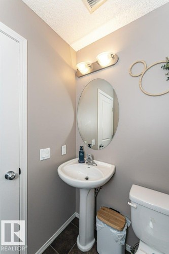 Bathroom featuring toilet and a textured ceiling - 6649 Cardinal Road Sw, Edmonton, AB - Indoor Photo Showing Bathroom