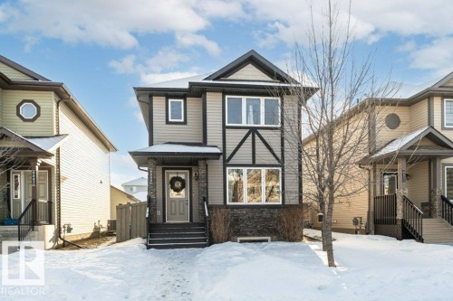View of front of home with stone siding - 6649 Cardinal Road Sw, Edmonton, AB - Outdoor With Facade