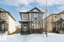 View of front of home with stone siding - 6649 Cardinal Road Sw, Edmonton, AB  - Outdoor With Facade 