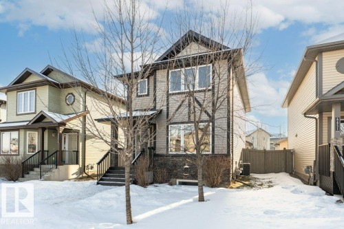 View of front of home featuring stone siding - 6649 Cardinal Road Sw, Edmonton, AB - Outdoor With Facade