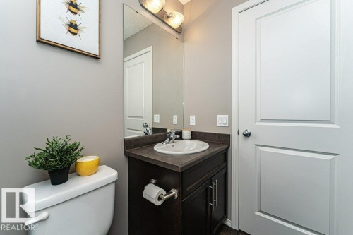 Half bath with vanity and toilet - 6649 Cardinal Road Sw, Edmonton, AB - Indoor Photo Showing Bathroom