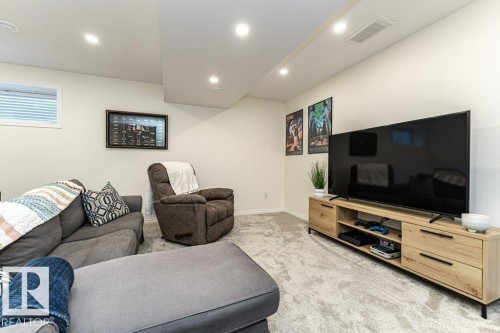 Living area with light colored carpet and recessed lighting - 6649 Cardinal Road Sw, Edmonton, AB - Indoor