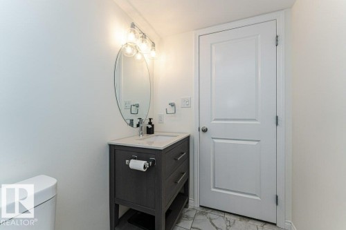 Bathroom featuring vanity and light marble finish floors - 6649 Cardinal Road Sw, Edmonton, AB - Indoor