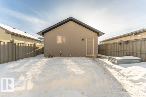 Snow covered property with a fenced backyard - 6649 Cardinal Road Sw, Edmonton, AB - Outdoor With Exterior