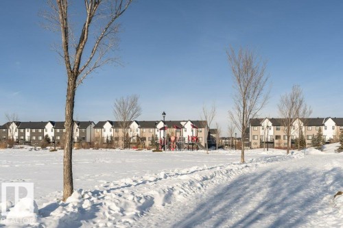 Yard layered in snow with a residential view - 6649 Cardinal Road Sw, Edmonton, AB - Outdoor With Facade