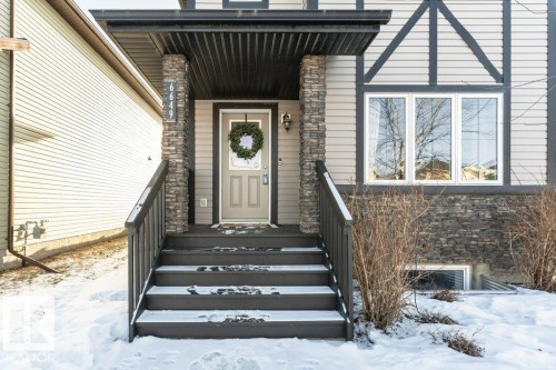 Snow covered property entrance featuring stone siding - 6649 Cardinal Road Sw, Edmonton, AB - Outdoor