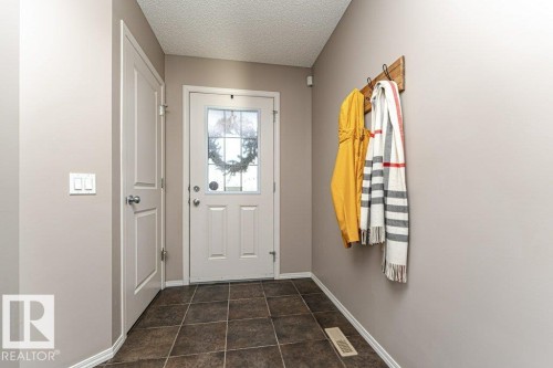 Doorway featuring a textured ceiling and baseboards - 6649 Cardinal Road Sw, Edmonton, AB - Indoor Photo Showing Other Room