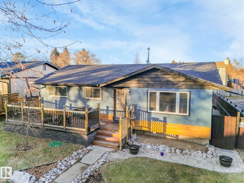 View of front of house with a wooden deck, roof with shingles, and crawl space - 5924 152A Avenue, Edmonton, AB 
