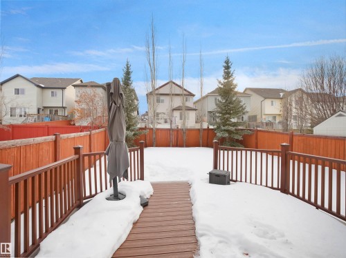 Snow covered deck featuring a residential view and a fenced backyard - 6115 11 Avenue, Edmonton, AB - Outdoor