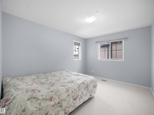 Carpeted bedroom featuring baseboards - 6115 11 Avenue, Edmonton, AB - Indoor Photo Showing Bedroom