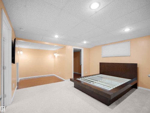 Rec Room featuring light colored carpet, a drop ceiling, and recessed lighting - 6115 11 Avenue, Edmonton, AB - Indoor
