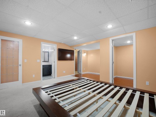 Recreation Room with a drop ceiling, ensuite bath, and light carpet - 6115 11 Avenue, Edmonton, AB - Indoor Photo Showing Bedroom