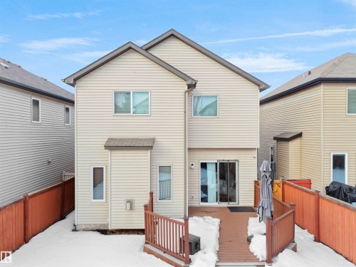 Snow covered back of property featuring a deck - 6115 11 Avenue, Edmonton, AB - Outdoor With Exterior