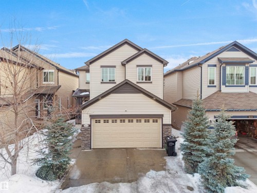 View of front facade with stone siding, driveway, and a garage - 6115 11 Avenue, Edmonton, AB - Outdoor