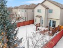Snow covered back of property featuring a fenced backyard, a residential view, and a wooden deck - 6115 11 Avenue, Edmonton, AB  - Outdoor 