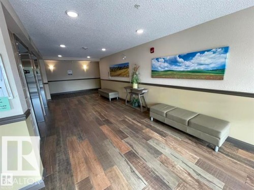 Community lobby with a textured ceiling and recessed lighting - 207 7021 South Terwillegar Drive, Edmonton, AB - Indoor Photo Showing Other Room