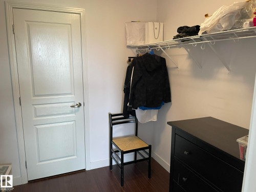 Walk in closet with dark wood finished floors - 207 7021 South Terwillegar Drive, Edmonton, AB - Indoor Photo Showing Other Room