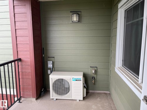Laundry area featuring wood walls - 207 7021 South Terwillegar Drive, Edmonton, AB -  With Exterior