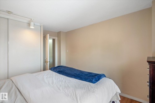 Bedroom featuring wood finished floors and baseboards - 304 9725 106 Street, Edmonton, AB - Indoor Photo Showing Bedroom