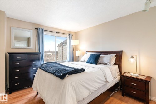 Bedroom with light wood-style floors and a textured ceiling - 304 9725 106 Street, Edmonton, AB - Indoor Photo Showing Bedroom
