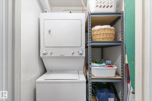 Laundry area with stacked washer and dryer - 304 9725 106 Street, Edmonton, AB - Indoor Photo Showing Laundry Room
