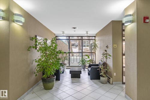 Community lobby with floor to ceiling windows - 304 9725 106 Street, Edmonton, AB - Indoor Photo Showing Other Room