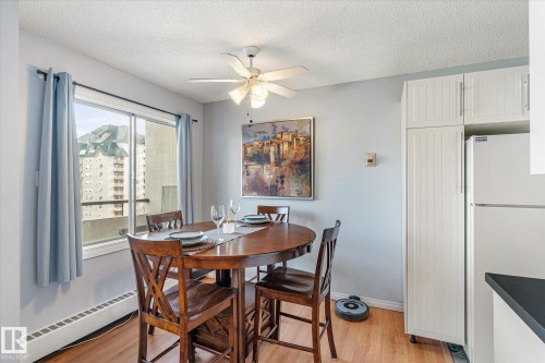 Dining space featuring light wood finished floors, a baseboard radiator, ceiling fan, and a textured ceiling - 304 9725 106 Street, Edmonton, AB - Indoor Photo Showing Dining Room