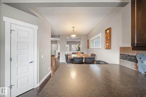 Dining area featuring a textured ceiling and dark wood-style flooring - 8107 224 Street Nw, Edmonton, AB - Indoor
