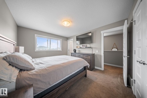 Bedroom featuring dark carpet and a textured ceiling - 8107 224 Street Nw, Edmonton, AB - Indoor Photo Showing Bedroom