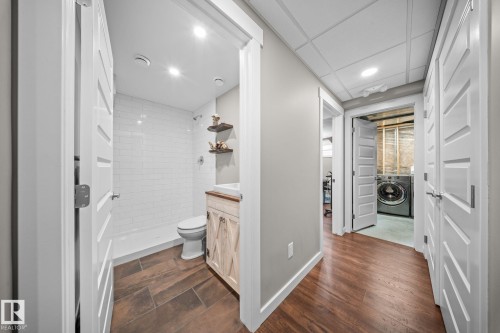 Full bath with vanity, a stall shower, washer / clothes dryer, recessed lighting, and dark wood-type flooring - 8107 224 Street Nw, Edmonton, AB - Indoor
