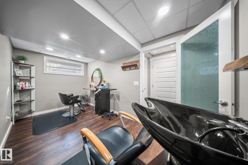 Misc room featuring dark wood-style floors, a drop ceiling, and recessed lighting - 8107 224 Street Nw, Edmonton, AB - Indoor