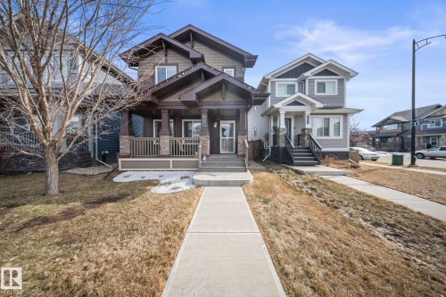 Craftsman inspired home featuring covered porch and a front yard - 8107 224 Street Nw, Edmonton, AB - Outdoor With Deck Patio Veranda With Facade