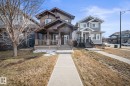 Craftsman inspired home featuring covered porch and a front yard - 8107 224 Street Nw, Edmonton, AB  - Outdoor With Deck Patio Veranda With Facade 