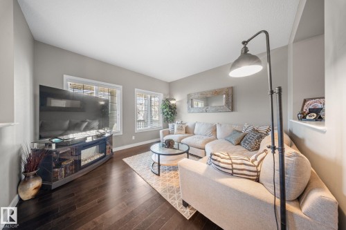Living room featuring baseboards and hardwood / wood-style flooring - 8107 224 Street Nw, Edmonton, AB - Indoor Photo Showing Living Room