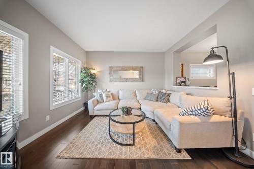 Living area with baseboards and hardwood / wood-style floors - 8107 224 Street Nw, Edmonton, AB - Indoor Photo Showing Living Room