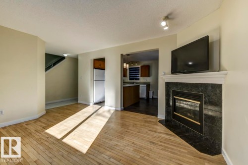 16 4020 21 Street, Edmonton, AB - Indoor Photo Showing Living Room With Fireplace