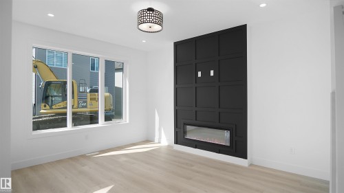 Unfurnished living room with light wood finished floors, recessed lighting, and a fireplace - 711 31 Avenue, Edmonton, AB - Indoor Photo Showing Living Room With Fireplace